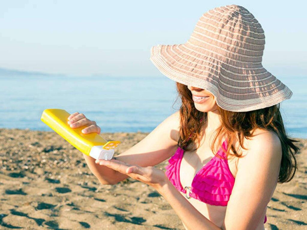 A woman applying sunscreen